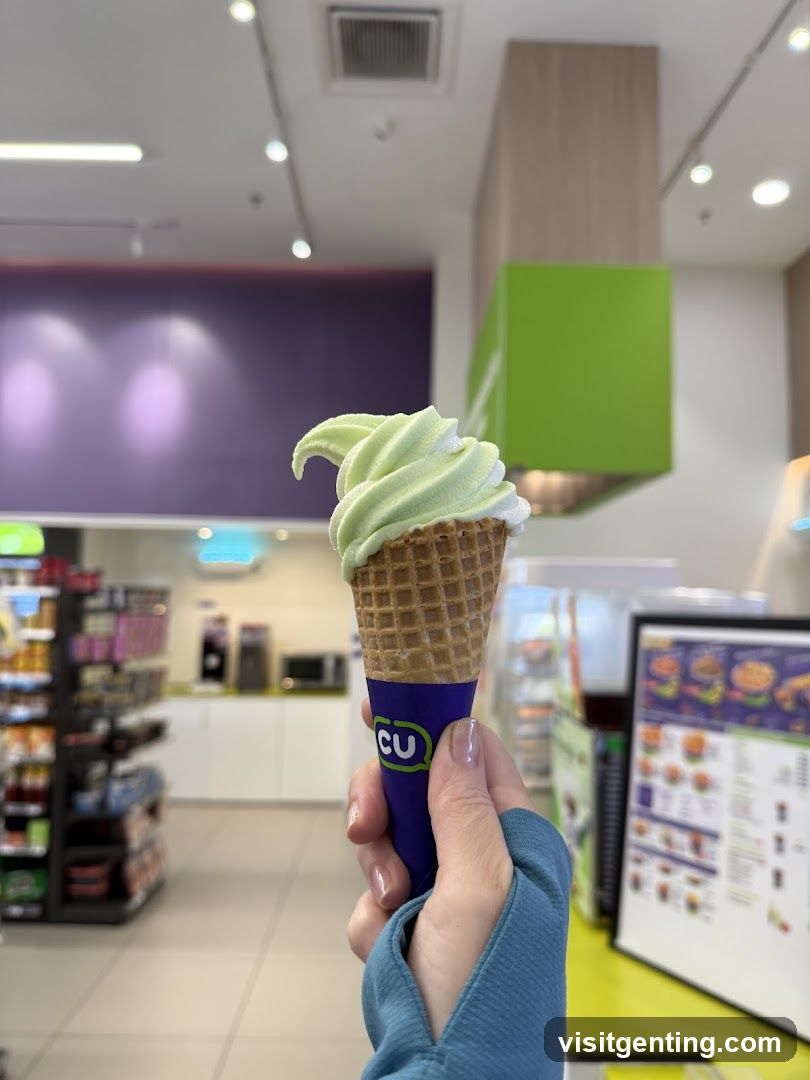 Hand holding ice cream cone in store