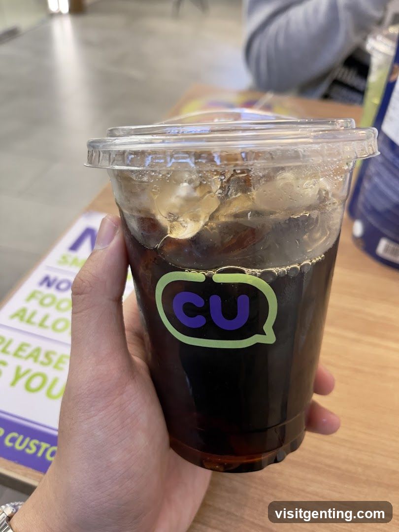 Hand holding CU drink