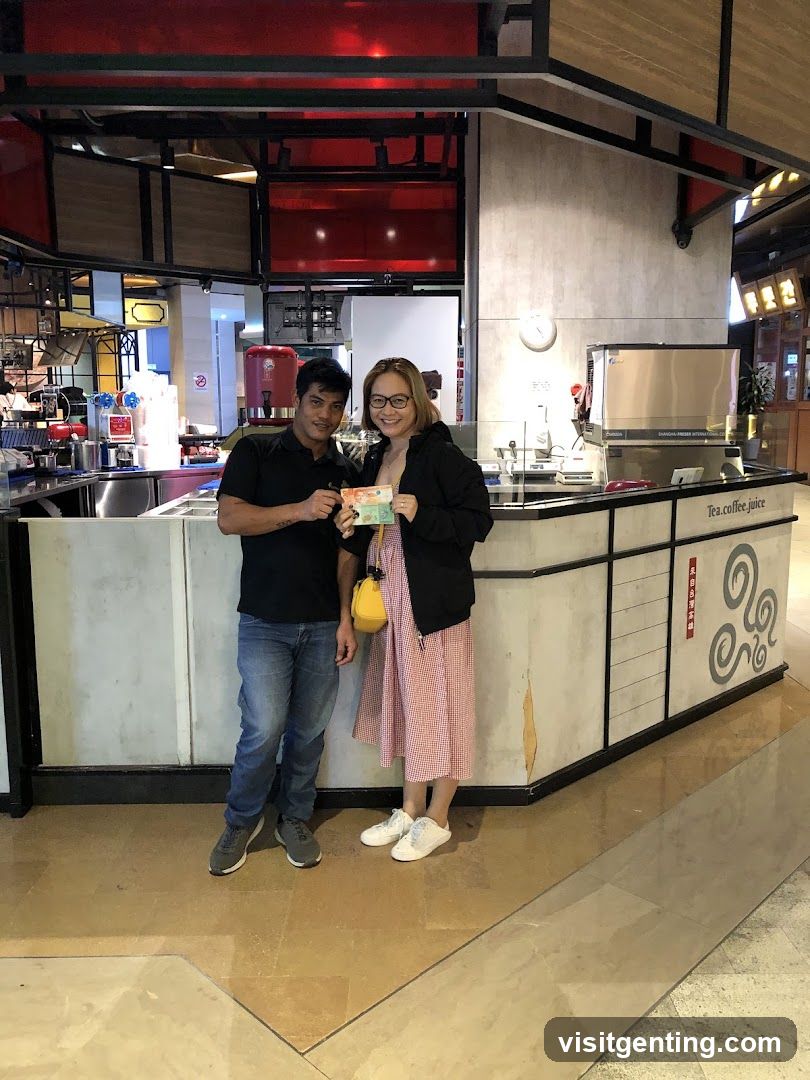 Two people posing in front of a beverage counter