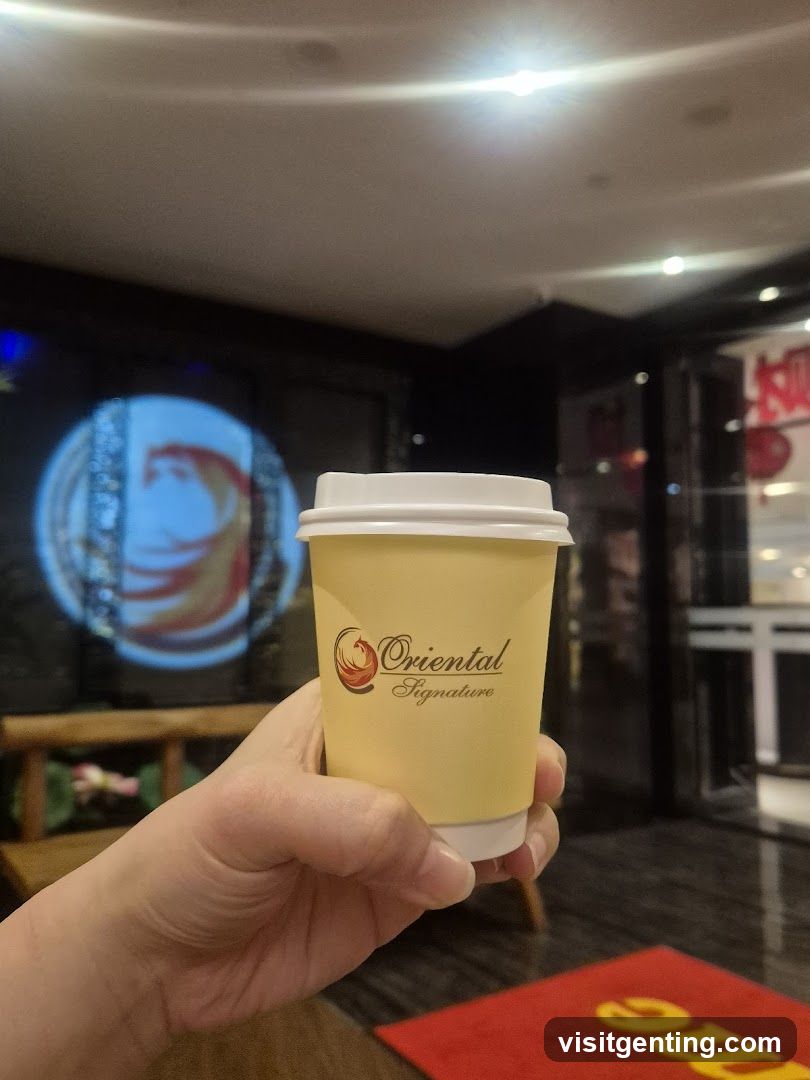 Hand holding coffee cup inside a shop