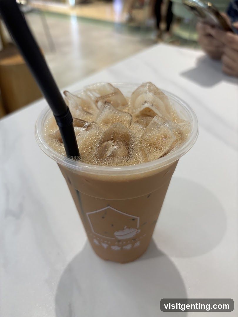 Iced beverage in plastic cup with black straw