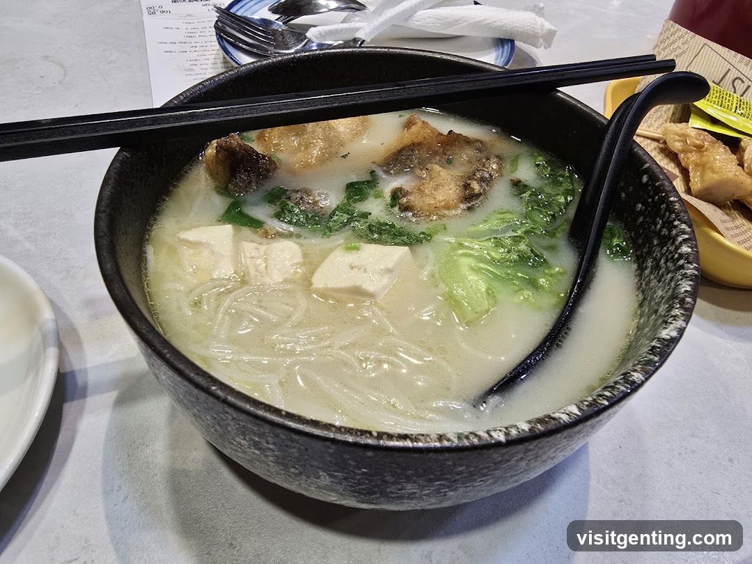 Bowl of soup with chopsticks and spoon