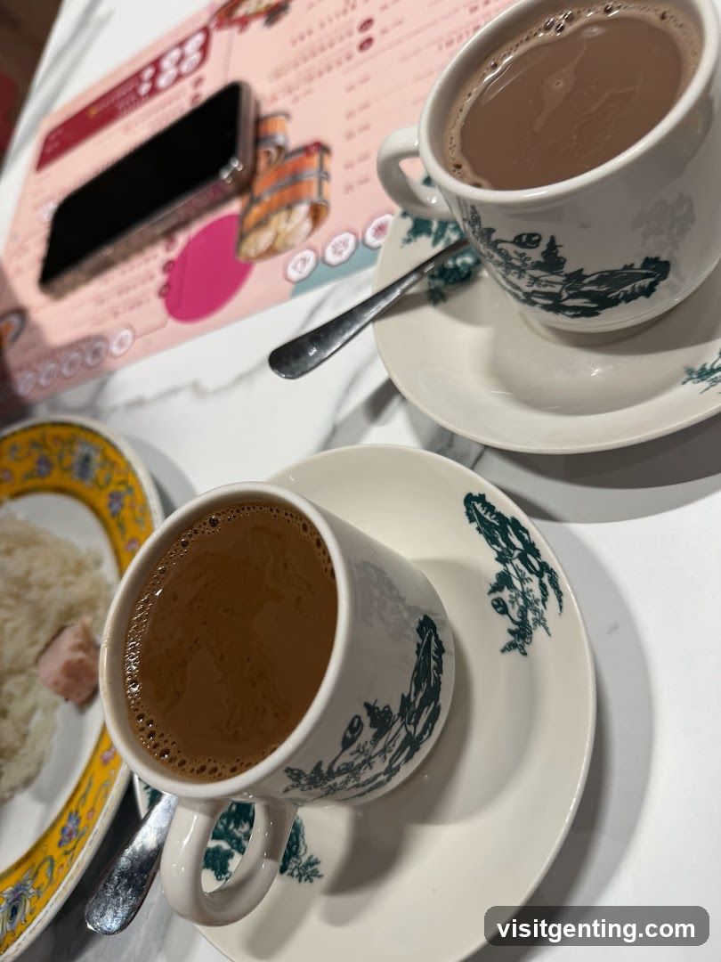 Two cups of coffee and a plate of food