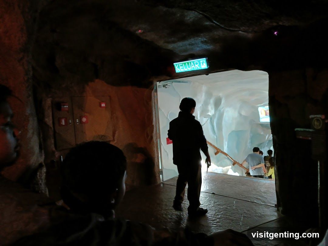 People walking down an icy tunnel