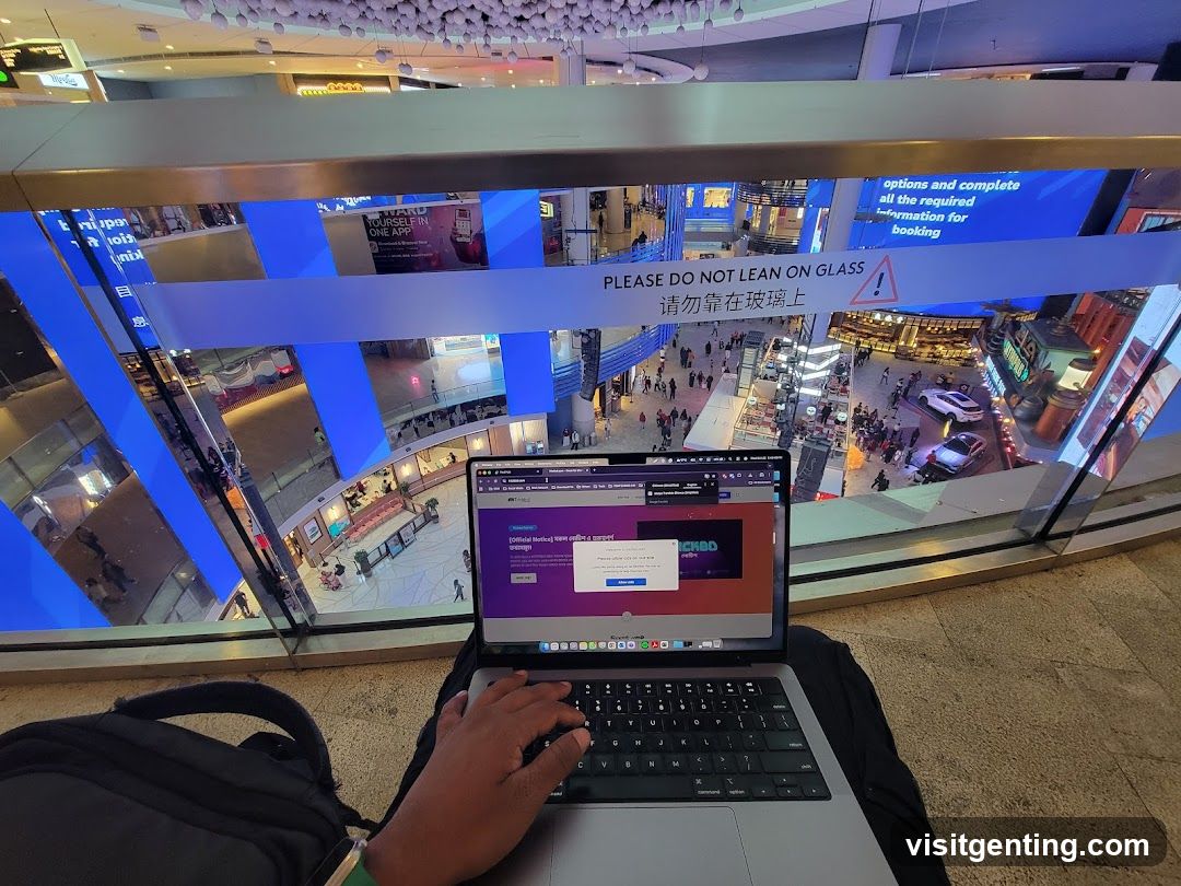 Person working on laptop in a mall