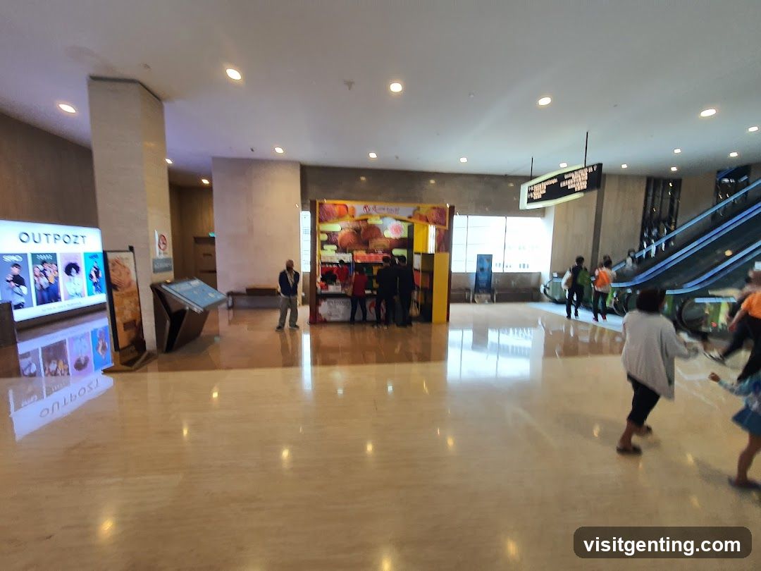 Indoor mall concourse with kiosks and escalators