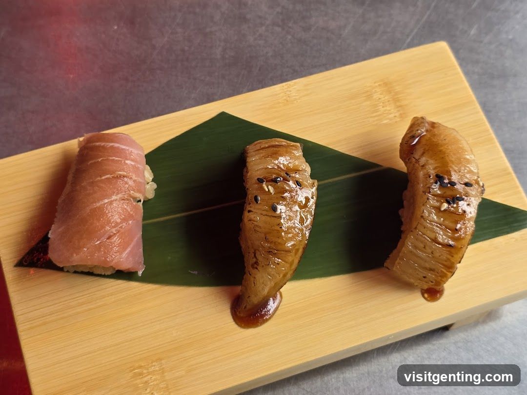 Three pieces of sushi on a wooden board