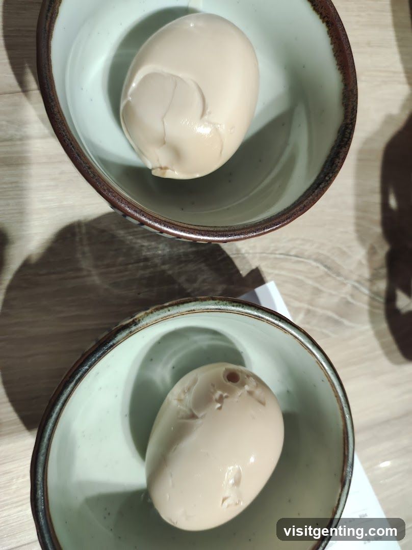 Two Marinated Eggs in Bowls