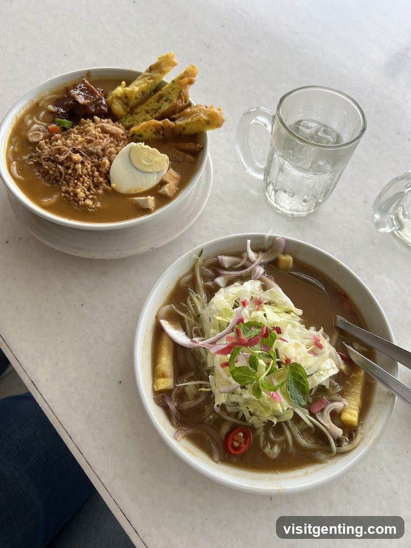 Table with Two Bowls of Noodles and a Glass of Water