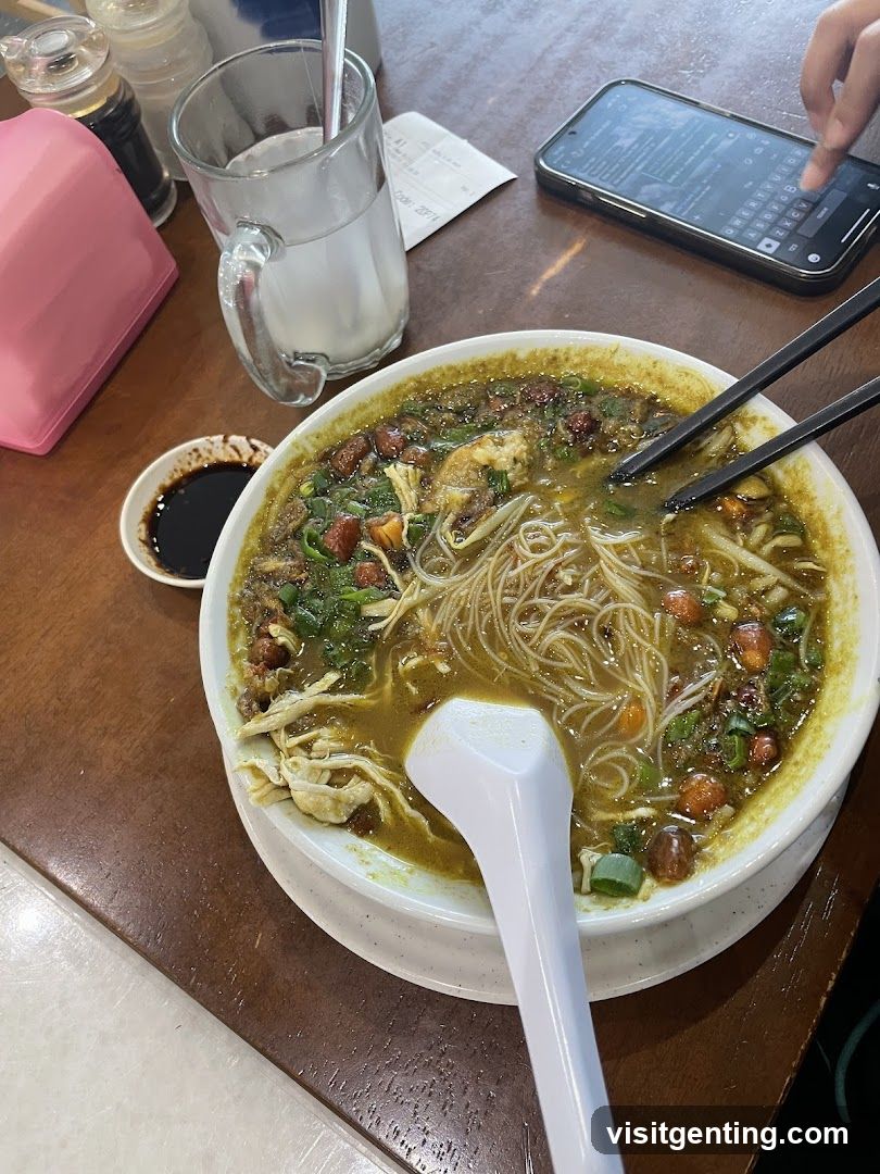 Table with noodle soup and dining accessories