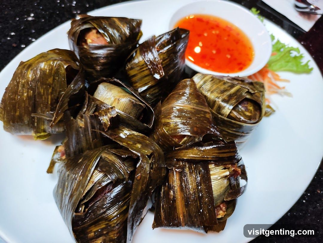 Food Plate with Leaf-Wrapped Dishes and Sauce