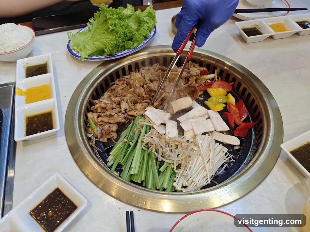 Grilled meat and vegetables on a tabletop grill