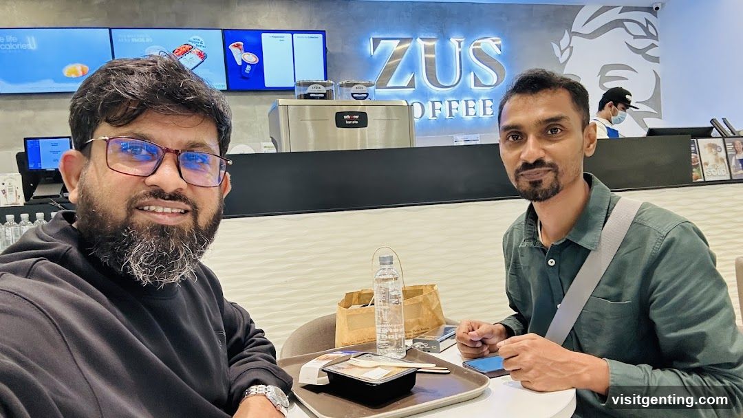 Two men at a coffee shop counter