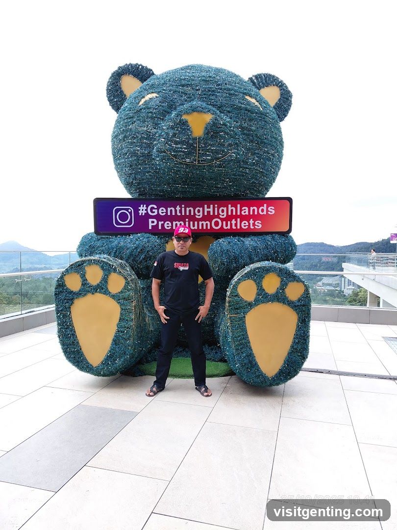 Person posing with large bear sculpture at Genting Highlands Premium Outlets