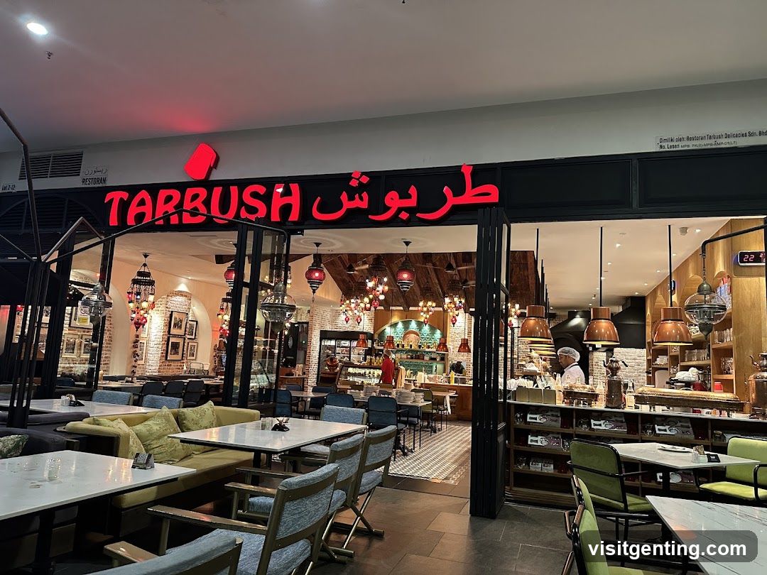 Storefront with red neon sign displaying "TARBUSH" in English and Arabic script above glass doors. Interior visible through entrance showing dining area with tables, chairs, hanging lanterns, brick walls, and staff at counter. Modern lighting fixtures and open layout.