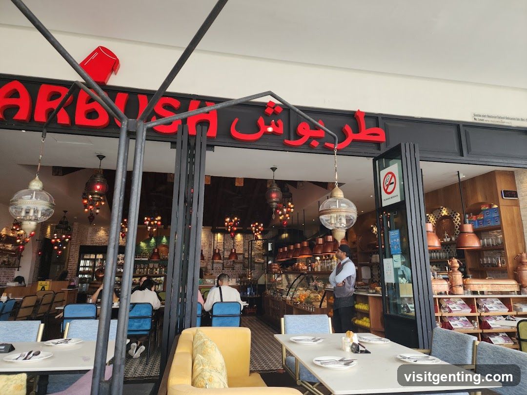 Exterior view of restaurant entrance with red Arabic script signage reading 'طربوش' and partial English name 'ARBUSH'. Black metal frame overhead with hanging lanterns. Interior shows patrons seated at tables with blue chairs, staff present, and display counters. No menu board or printed material visible.