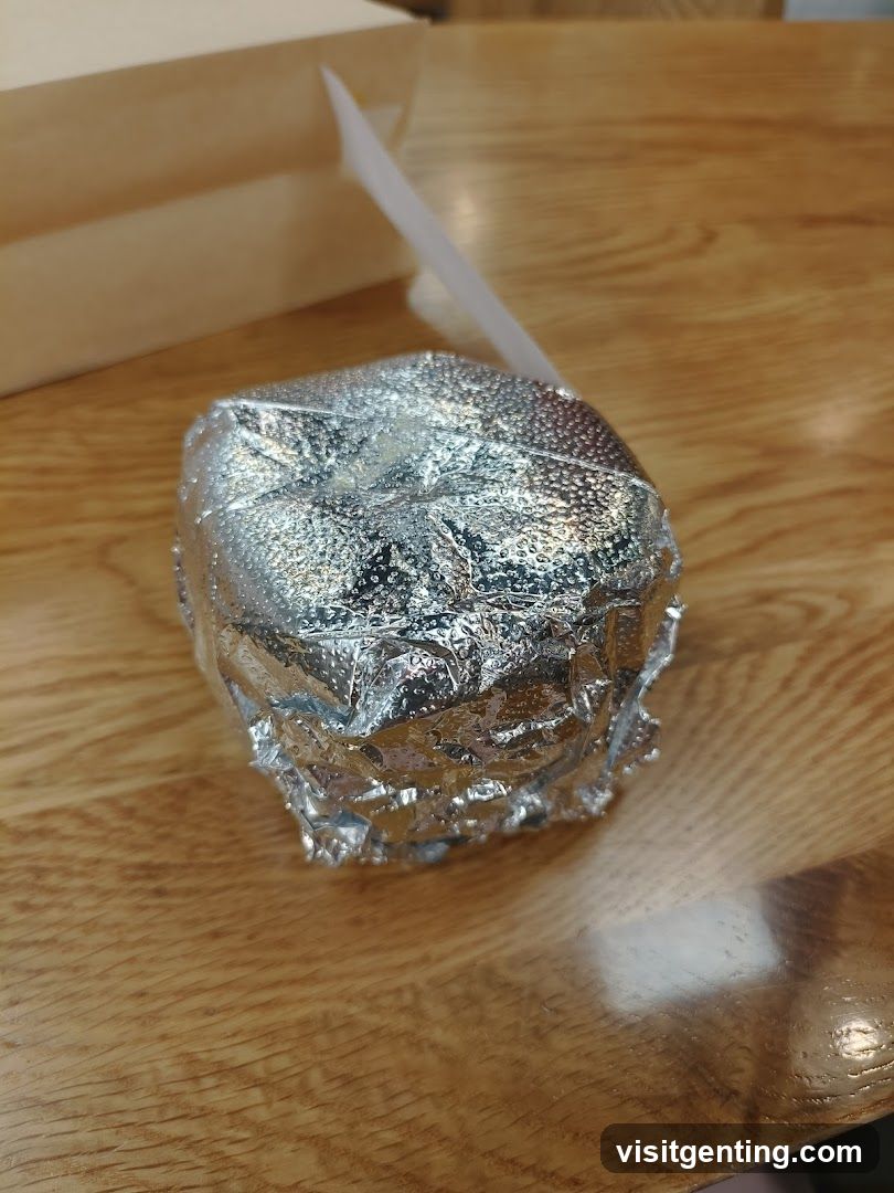 Food wrapped in foil on wooden table