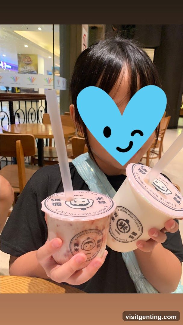 Person holding drinks in indoor setting