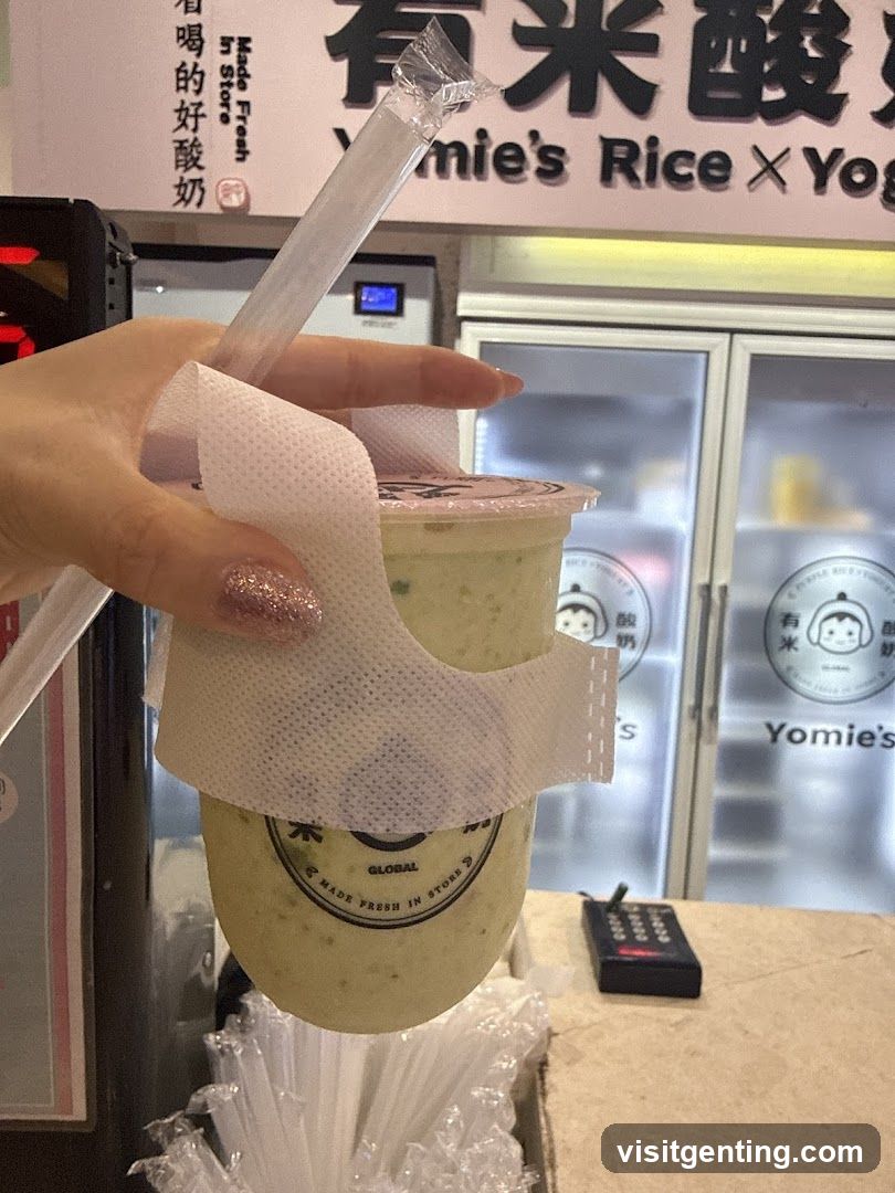 Hand holding drink at Yomie's Rice × Yogurt store