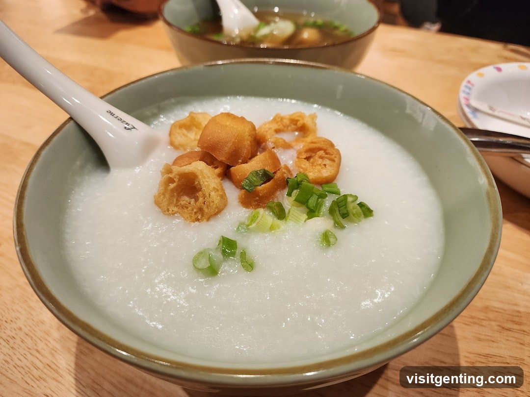 Bowl of congee with fried dough and green onions