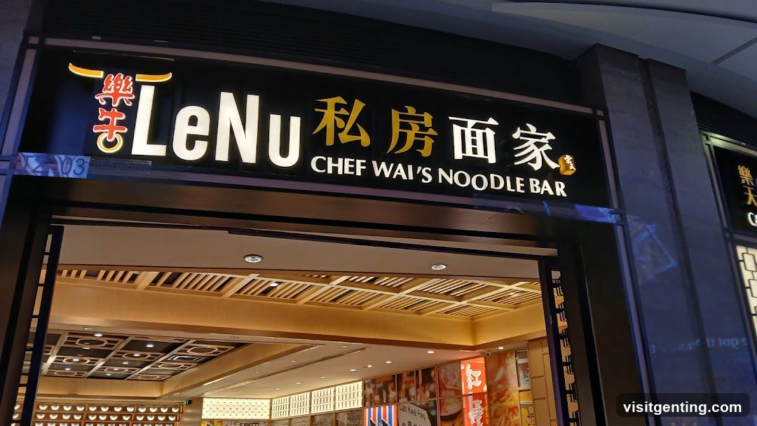 Exterior storefront sign with illuminated English and Chinese characters. The sign reads 'LeNu 私房面家' and 'CHEF WAI'S NOODLE BAR'. The entrance is open, revealing a warmly lit interior with wooden ceiling panels and decorative lighting. A partial view of the interior shows promotional posters on the walls.